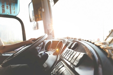 Photo of a driver in a truck cab.
